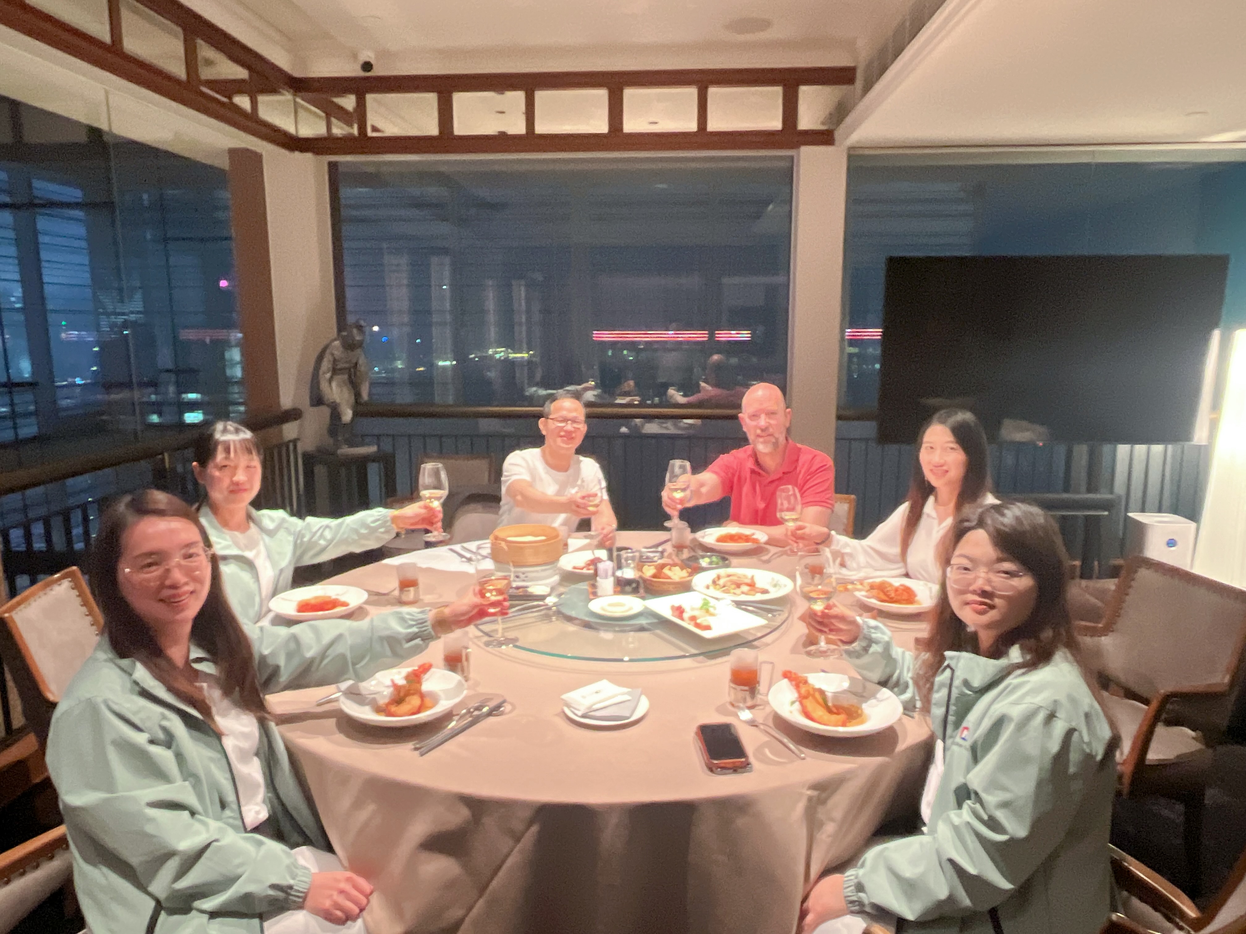 NAIKE GROUP team sharing a business dinner with overseas clients